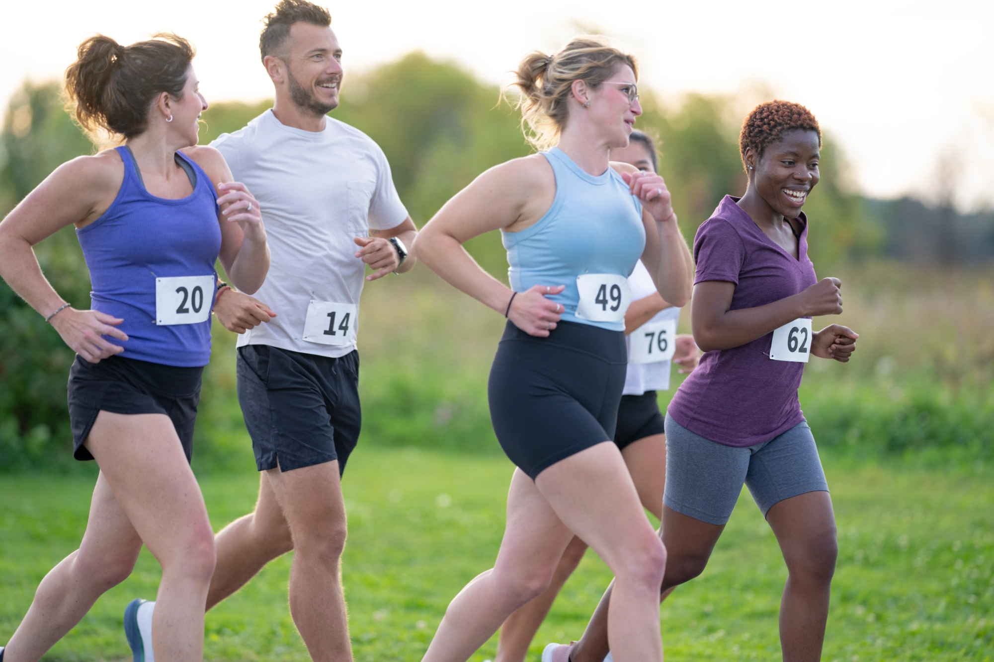 Group of people running outdoors in a race.